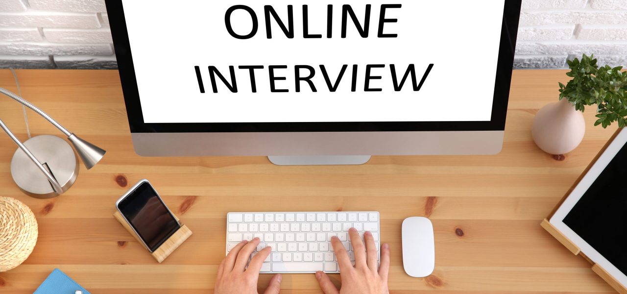 Man using computer for online job interview at table, top view Man using computer for online job interview at table, top view